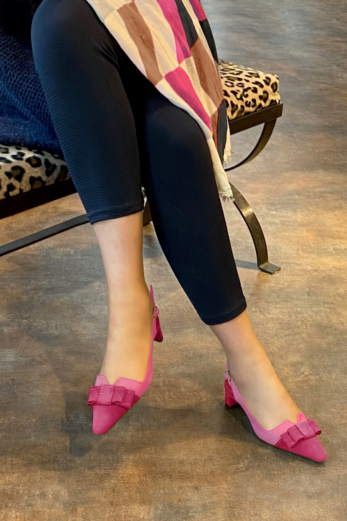 Women's fuchsia pink and hot pink elegant slingback heels, with a bow on the front. Tapered toe. Low kitten heels - Worn view